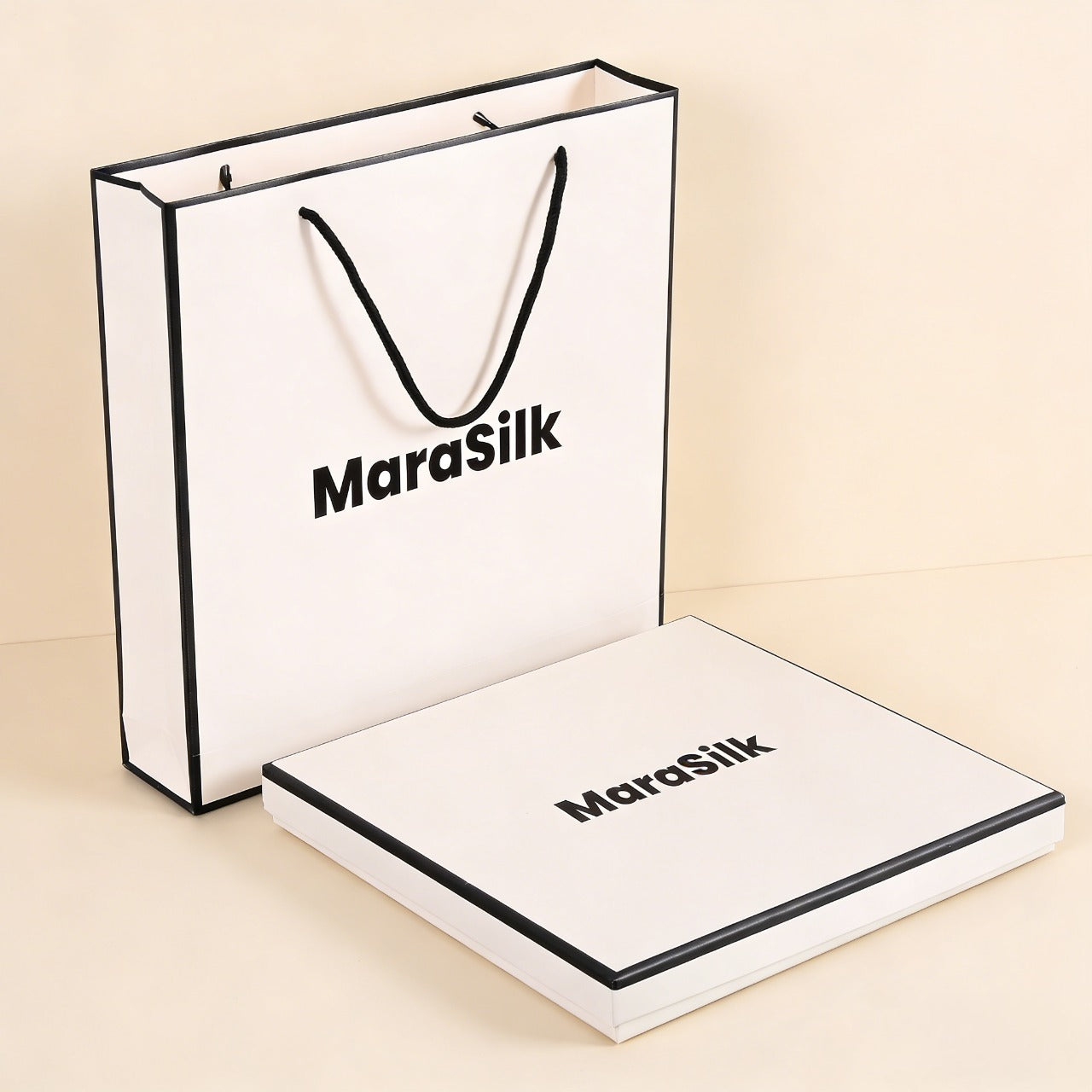 MaraSilk branded paper bag and box on a beige background
